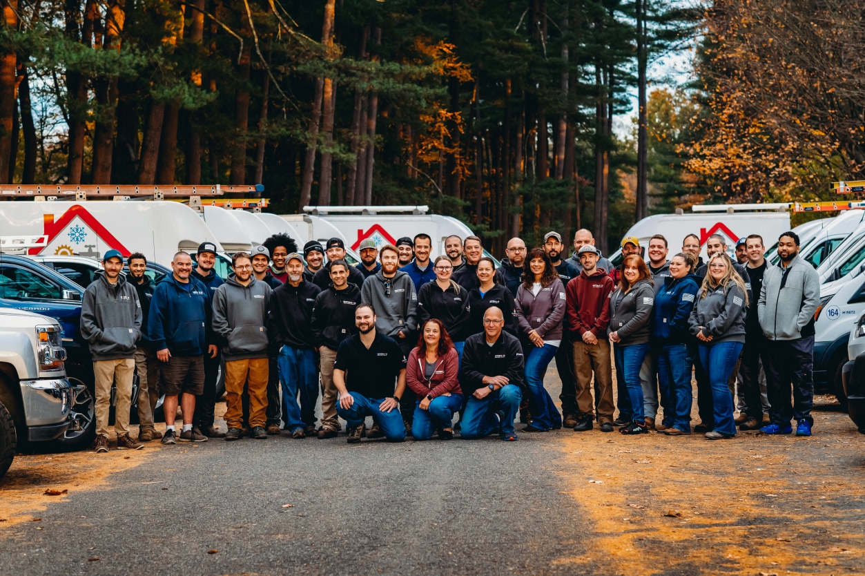 The team at Western Mass Heating, Cooling & Plumbing in front of their fleet